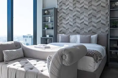 a bedroom with a bed and a couch at The Address JBR, Address Beach Resort, Marina View - Onelink in Dubai