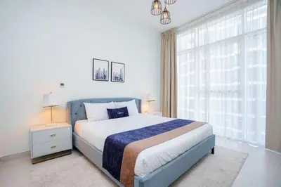 a bedroom with a bed and a large window at CitiHome - Spacious 2BR - Park Gate Residences in Dubai