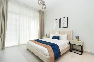 a white bedroom with a large bed and a window at CitiHome - Spacious 2BR - Park Gate Residences in Dubai