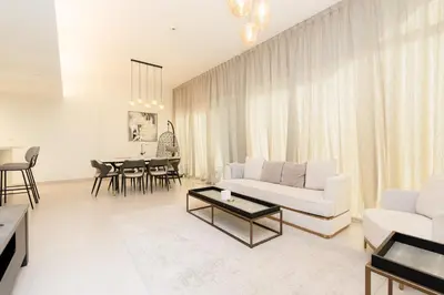a living room with a white couch and a table at CitiHome - Spacious 2BR - Park Gate Residences in Dubai