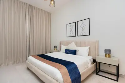 a bedroom with a large white bed with blue accents at CitiHome - Spacious 2BR - Park Gate Residences in Dubai