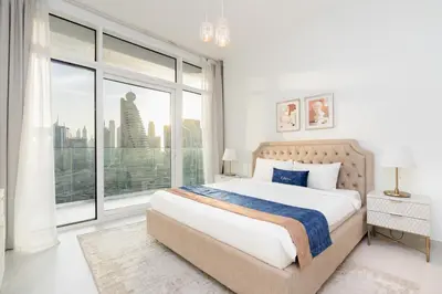 a bedroom with a bed and a large window at CitiHome - Spacious 1BR - Park Gate Residences in Dubai