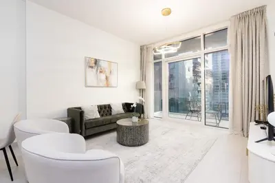 a living room with white furniture and a large window at CitiHome - Spacious 1BR - Park Gate Residences in Dubai