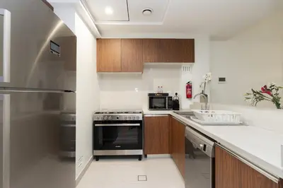 a kitchen with a stove and a microwave at CitiHome - Spacious 1BR - Park Gate Residences in Dubai