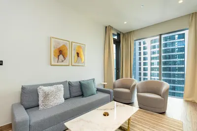 a living room with a couch and two chairs at CitiHome - Iconic 1BR Jumeirah Living Marina Gate in Dubai