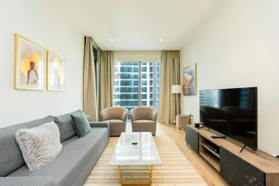 a living room with a couch and a tv at CitiHome - Iconic 1BR Jumeirah Living Marina Gate in Dubai