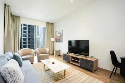 a living room with a couch and a flat screen tv at CitiHome - Iconic 1BR Jumeirah Living Marina Gate in Dubai