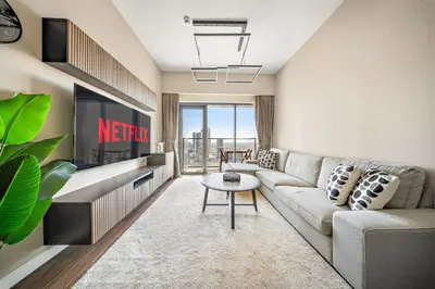 a living room with a couch and a table at VayK -Downtown Dubai Chic 1BR Retreat in Dubai