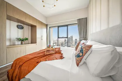 a bedroom with a large white bed with a window at VayK -Downtown Dubai Chic 1BR Retreat in Dubai