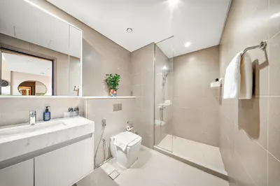 a bathroom with a sink and a toilet and a shower at VayK -Downtown Dubai Chic 1BR Retreat in Dubai