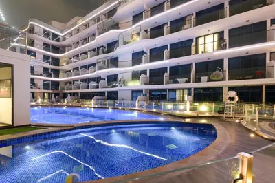 a large apartment building with a large swimming pool at Luxury 2BR with Private Pool Balcony Arjan in Dubai