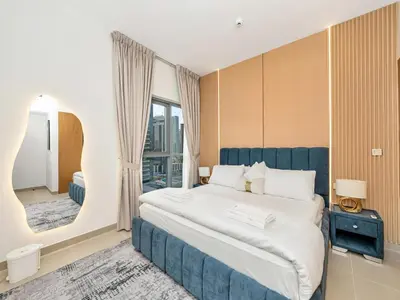 a bedroom with a large bed and a mirror at Elegant 1BR in Bellevue Towers Downtown Dubai in Dubai