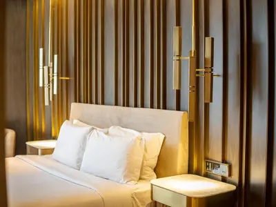 a hotel room with a bed and a side table at Daniels Spacious 3BR with Maid at Five Palm Jumeirah in Dubai