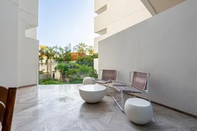 two chairs and a table in a room with a large window at Daniels Spacious 3BR with Maid at Five Palm Jumeirah in Dubai