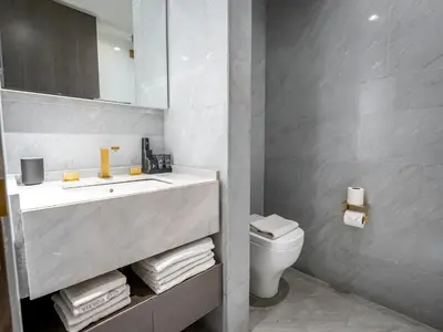 a bathroom with a sink and a toilet at Daniels Spacious 3BR with Maid at Five Palm Jumeirah in Dubai