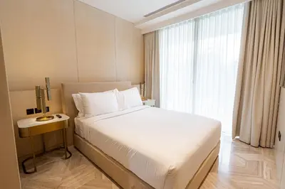 a bedroom with a white bed and a window at Daniels Spacious 3BR with Maid at Five Palm Jumeirah in Dubai