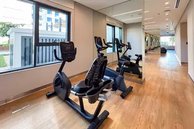 a gym with treadmills and ellipticals in a building at PVH - Chic Pool View 2BR Near Dubai Hills Park - Park Field Tower 2 in Dubai