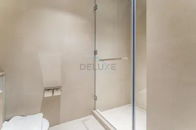 a shower with a glass door in a bathroom at Direct Walking Access to Dubai Mall and Burj Khalifa with Metro Connectivity to Prime Attractions - Vida Dubai Mall Tower 2, Downtown Dubai by Deluxe Holiday Homes in Dubai