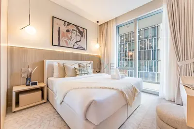 a bedroom with a large white bed and a window at Direct Walking Access to Dubai Mall and Burj Khalifa with Metro Connectivity to Prime Attractions - Vida Dubai Mall Tower 2, Downtown Dubai by Deluxe Holiday Homes in Dubai