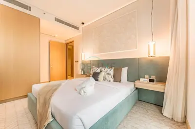 a bedroom with a large white bed in a room at Direct Walking Access to Dubai Mall and Burj Khalifa with Metro Connectivity to Prime Attractions - Vida Dubai Mall Tower 2, Downtown Dubai by Deluxe Holiday Homes in Dubai