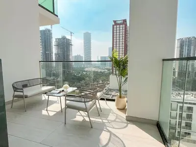 a balcony with chairs and a table on a building at Dubai Premium 2BR with Private Pool and Balcony! in Dubai