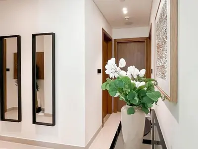 a vase with white flowers in a hallway with mirrors at Dubai Premium 2BR with Private Pool and Balcony! in Dubai