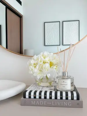 a vase of flowers sitting on top of a book at Dubai Premium 2BR with Private Pool and Balcony! in Dubai