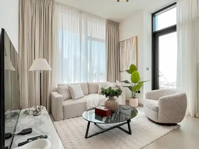 a living room with a couch and a chair and a table at Dubai Premium 2BR with Private Pool and Balcony! in Dubai