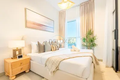 a white bedroom with two beds and a window at Steps from Dubai Hills Mall, Near Scenic Park, and Easily Connected to Dubai Top Attractions - Socio Tower 1, Dubai Hills by Deluxe Holiday Homes in Dubai