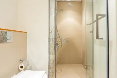 a bathroom with a shower with a toilet and a sink at Steps from Dubai Hills Mall, Near Scenic Park, and Easily Connected to Dubai Top Attractions - Socio Tower 1, Dubai Hills by Deluxe Holiday Homes in Dubai