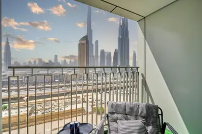 a chair on a balcony with a view of the city at Stylish 4BR with Burj View and Dubai Mall Connection in Dubai