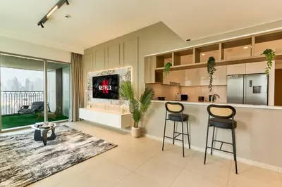 a kitchen with two bar stools and a counter at Stylish 4BR with Burj View and Dubai Mall Connection in Dubai