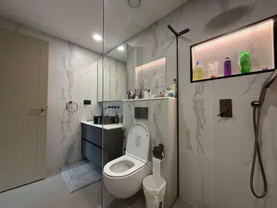 a bathroom with a white toilet and a sink at Urban Core - Downtown Dubai in Dubai