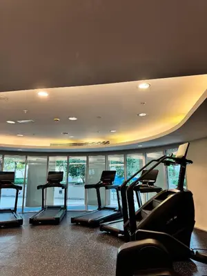 a gym with several cardio machines in a room at Urban Core - Downtown Dubai in Dubai