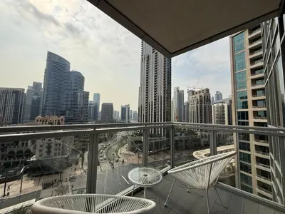 a balcony with two chairs and a view of a city at Urban Core - Downtown Dubai in Dubai