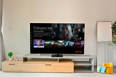 a television on a stand in a living room at 3bd apartment in downtown dubai in Dubai