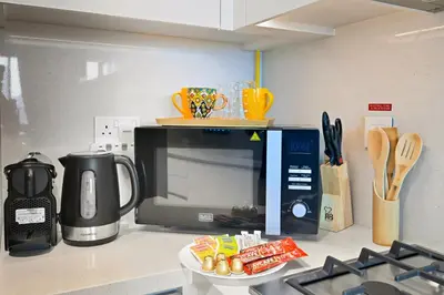 a kitchen counter with a microwave and a coffee maker at 3bd apartment in downtown dubai in Dubai