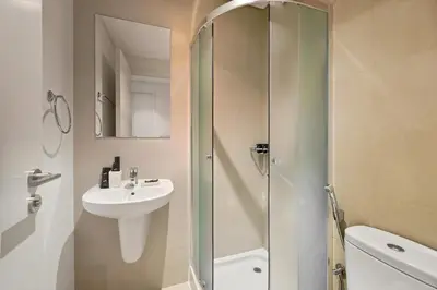 a bathroom with a shower and a sink and a toilet at 3bd apartment in downtown dubai in Dubai