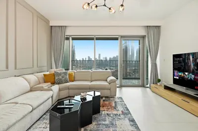 a living room with a couch and a flat screen tv at 3bd apartment in downtown dubai in Dubai