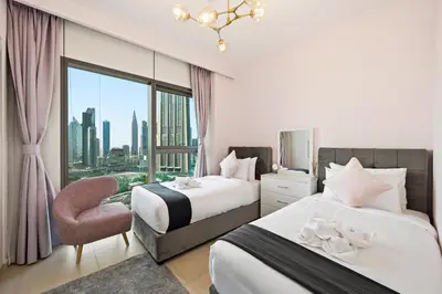 a hotel room with two beds and a window at 3bd apartment in downtown dubai in Dubai