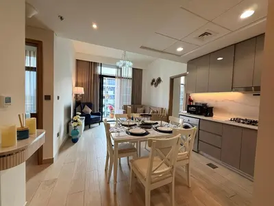 a kitchen and dining room with a table and chairs at Modern 2BR with Balcony in Azizi Riviera 23 in Dubai