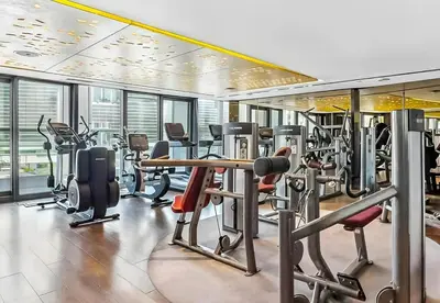 a gym with a lot of treadmills and machines at Stylish 1-Bedroom Apartment at DAMAC Paramount in Dubai