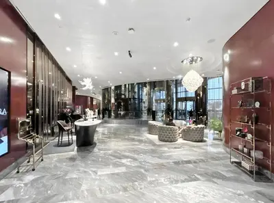a lobby of a building with tables and chairs at Stylish 1-Bedroom Apartment at DAMAC Paramount in Dubai