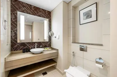 a bathroom with a sink and a mirror at Stylish 1-Bedroom Apartment at DAMAC Paramount in Dubai