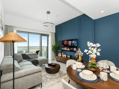 a living room with a couch and a table at Burj Royale 1BD Apartment 5mins walk to Dubai Mall and Burj Khalifa in Dubai