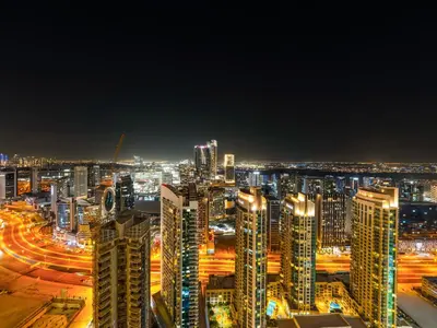 a night view of a city with tall buildings at Burj Royale 1BD Apartment 5mins walk to Dubai Mall and Burj Khalifa in Dubai