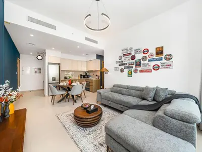 a living room with a couch and a table at Burj Royale 1BD Apartment 5mins walk to Dubai Mall and Burj Khalifa in Dubai