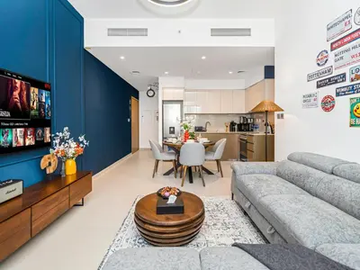 a living room with a couch and a table at Burj Royale 1BD Apartment 5mins walk to Dubai Mall and Burj Khalifa in Dubai