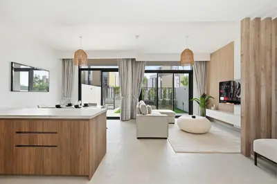 a kitchen and living room with a couch and a table at Incredible Family Townhouse Villa I Sleeps 10 in Dubai