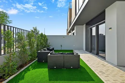 an internal courtyard of a house with green grass at Incredible Family Townhouse Villa I Sleeps 10 in Dubai